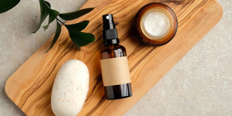 Room Spray Recipe: Rose & Sage Essential Oil 1 An amber spray bottle on a wooden board with herbal leaves