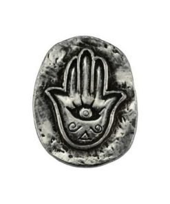 A pewter coin-shaped stone with a hand in the center and a third eye