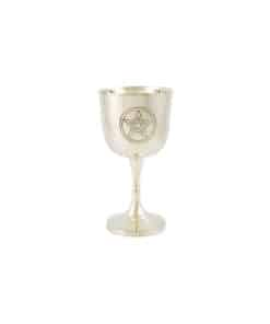 A small, silver chalice for wine that has a pentacle engraved into the side