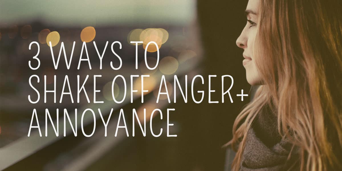 Contemplative woman looking out with a city nightscape in the background, accompanying text offering advice on managing emotions with a witchy twist: "3 ways to shake off anger + annoyance.