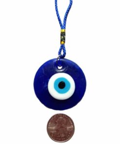 a blue glass circle with a white and light blue circle eye charm