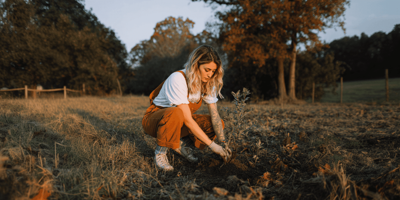 a woman planting a plant
