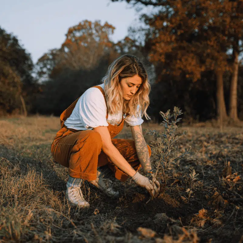 6 Spiritual & Eco-Friendly Ways Pagans and Wiccans Can Celebrate Earth Day 2 a woman planting a tree to celebrate earth day