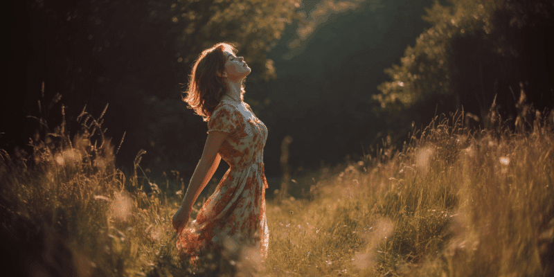a woman standing in a field in a sundress