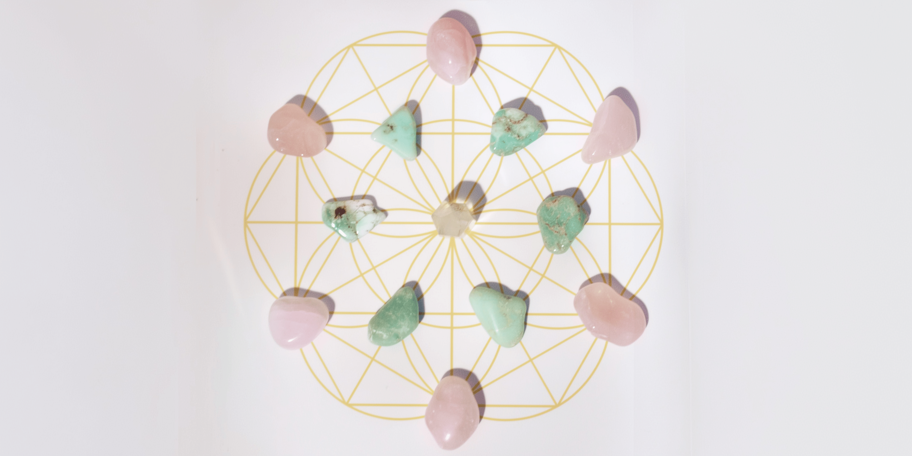crystal grid with rose quartz and chrysoprase crystals and a rose quartz at the center