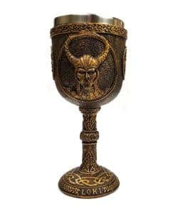 A brown resin chalice with loki carve into it