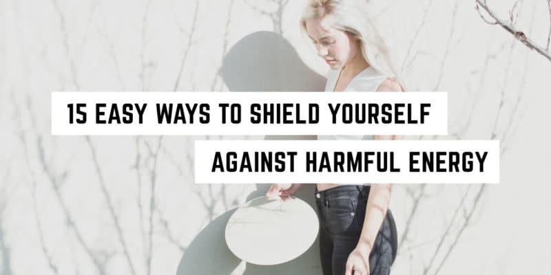 15 Ways to Shield Yourself against Harmful Energy 4 A thoughtful young woman holding a shield with text overlay "15 easy ways to shield yourself against harmful energy with witchy wisdom.