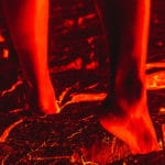 A person walking across lava barefoot