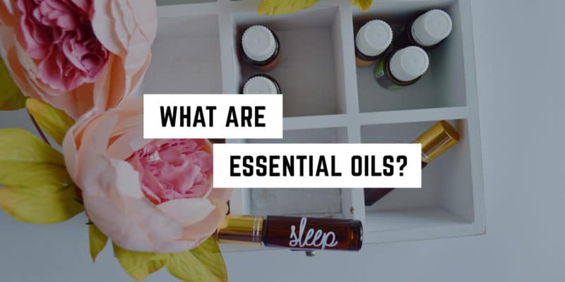 What are Essential Oils? 9 Aromatic ambiance: a collection of essential oils accompanied by fresh blooms in a witchy metaphysical shop, evoking a sense of holistic well-being.