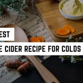 A cozy, witchy kitchen scene featuring ingredients for making a natural remedy, with the caption "the best fire cider recipe for colds + flu".