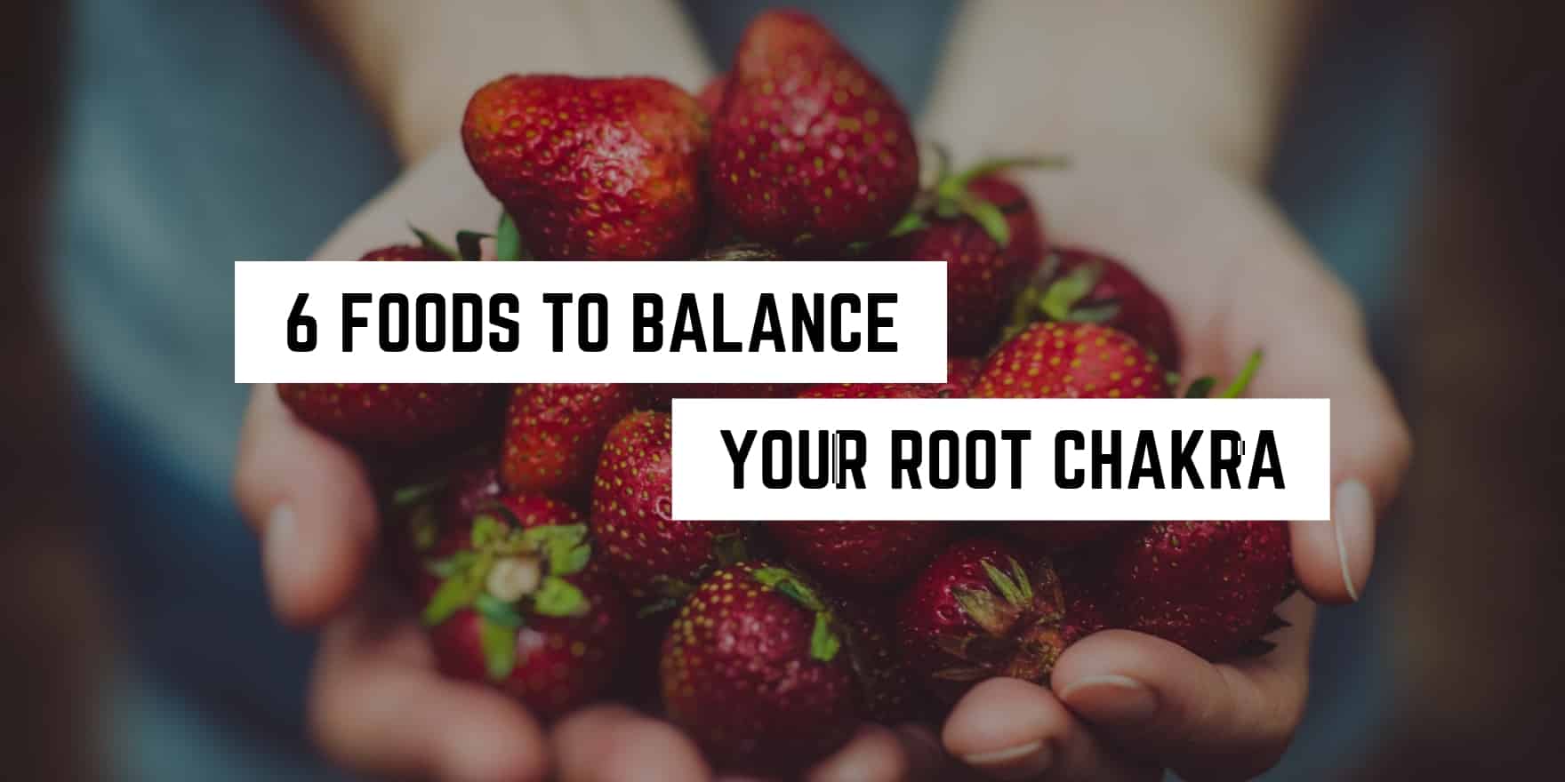 Cupped hands holding fresh strawberries with a caption suggesting they're one of six foods to balance your root chakra, perfect for your spiritual regimen.