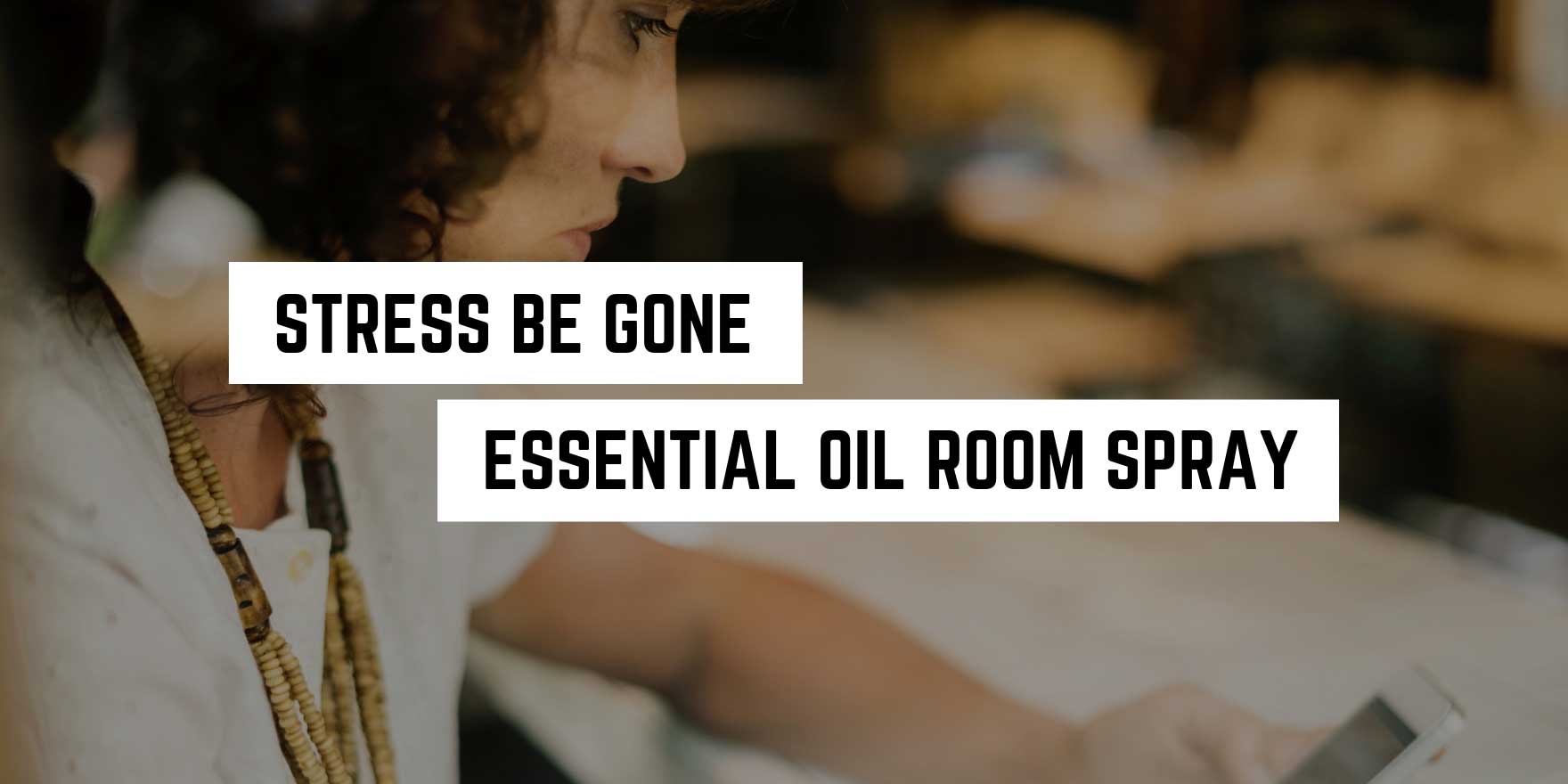 Woman concentrating on her phone in a serene setting, with a caption promoting a witchy essential oil room spray for stress relief.