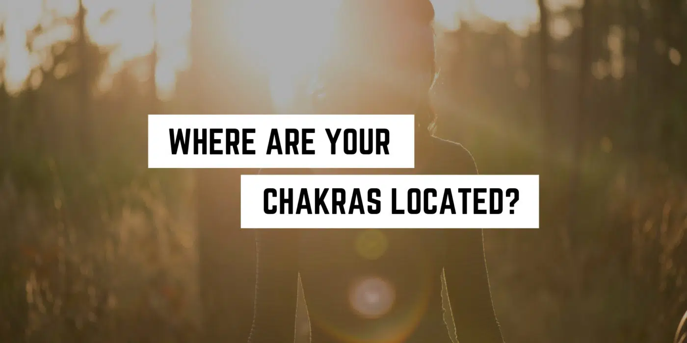 Where are the Chakras Located? 1 Silhouette of a person meditating in nature with lens flare, inviting reflection on spiritual energy centers with the question 'where are your chakras located?'. Perfect for followers of new age spirituality.