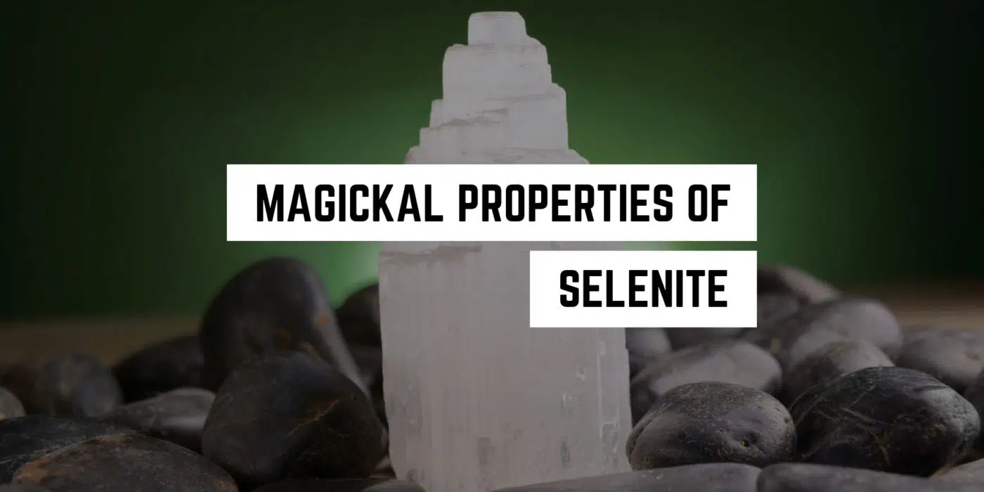 Magical Properties of Selenite | Selenite Materia Magicka 1 A selenite crystal tower stands amidst smooth pebbles, evoking a sense of tranquility and the mystical allure of new age product healing.