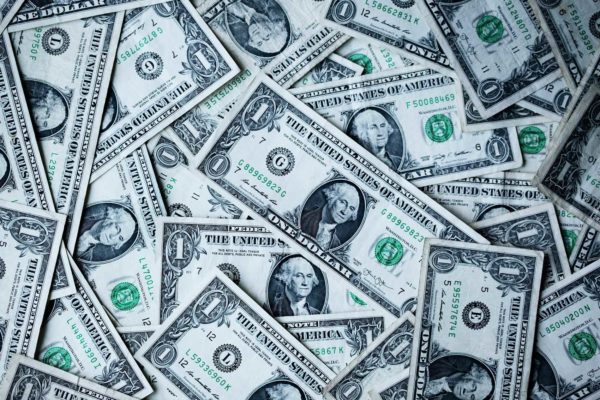 Free Witchcraft Items 4 A scattered array of variously oriented one-dollar bills covering the surface, now infused with a spiritual essence.