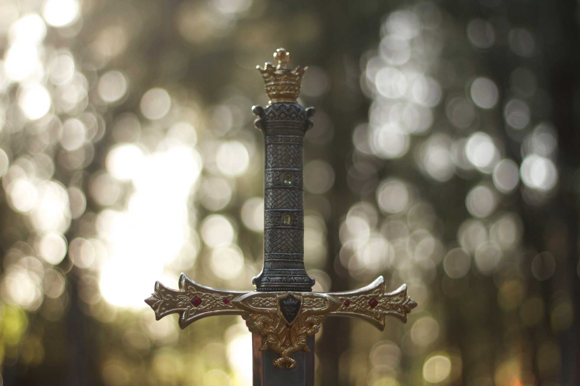 An elegant sword with intricate designs on the hilt stands against a bokeh background, evoking a sense of adventure and timeless legend in a new age product manner.