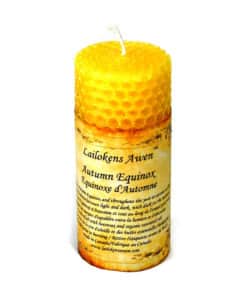 A yellow beeswax candle with a yellow label on the side
