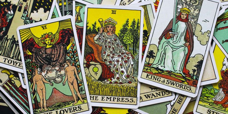 3 Tarot Card Activities for Beginners 8 A vibrant collection of tarot cards, a new age product, spread out, with "the empress" card drawing focus amidst various other richly illustrated symbols and figures.