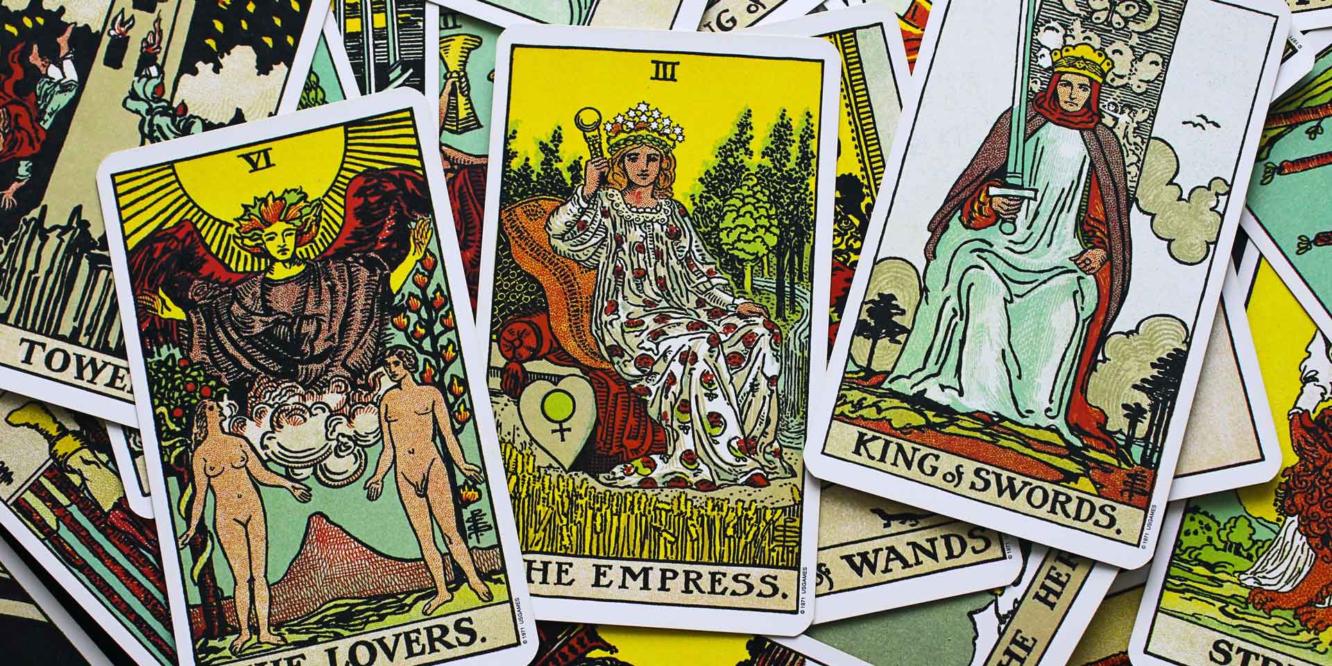 A vibrant collection of tarot cards, a new age product, spread out, with "the empress" card drawing focus amidst various other richly illustrated symbols and figures.