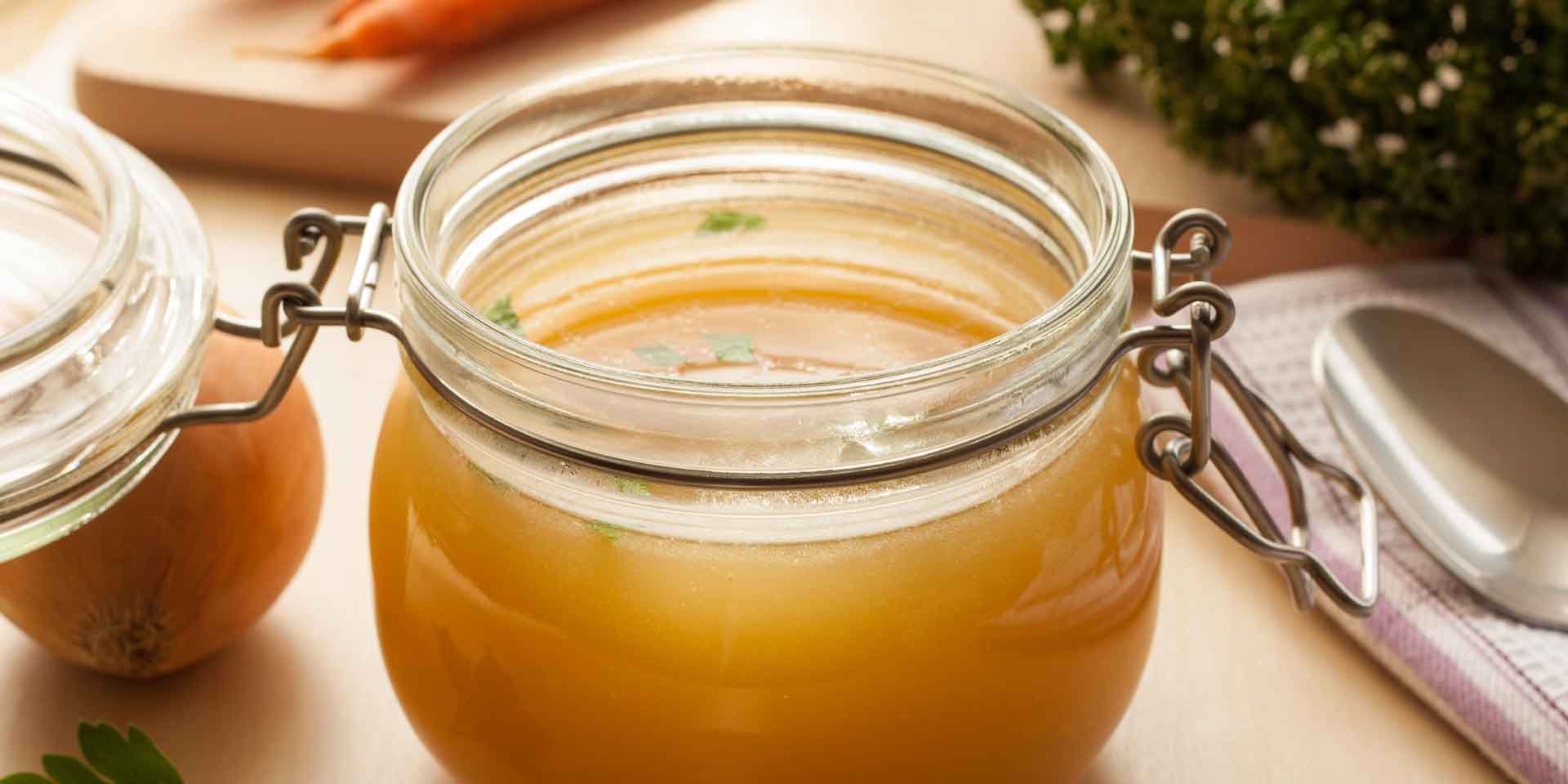 A jar of homemade chicken broth, infused with metaphysical herbs, ready to enhance the flavor of various dishes.