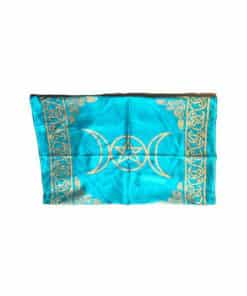 a bright blue altar cloth with a triple moon and a star in the center