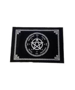 a black cloth pendulum mat with a celtic knot border, pentacle in the center, and words on it