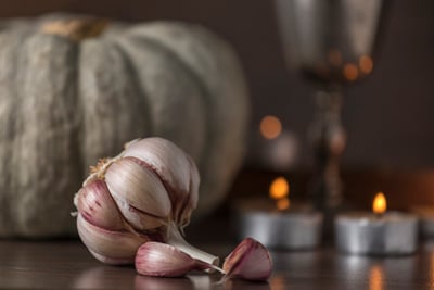 Garlic Magical Properties | Herbs For Protection 2 A bulb of garlic on an altar with candles