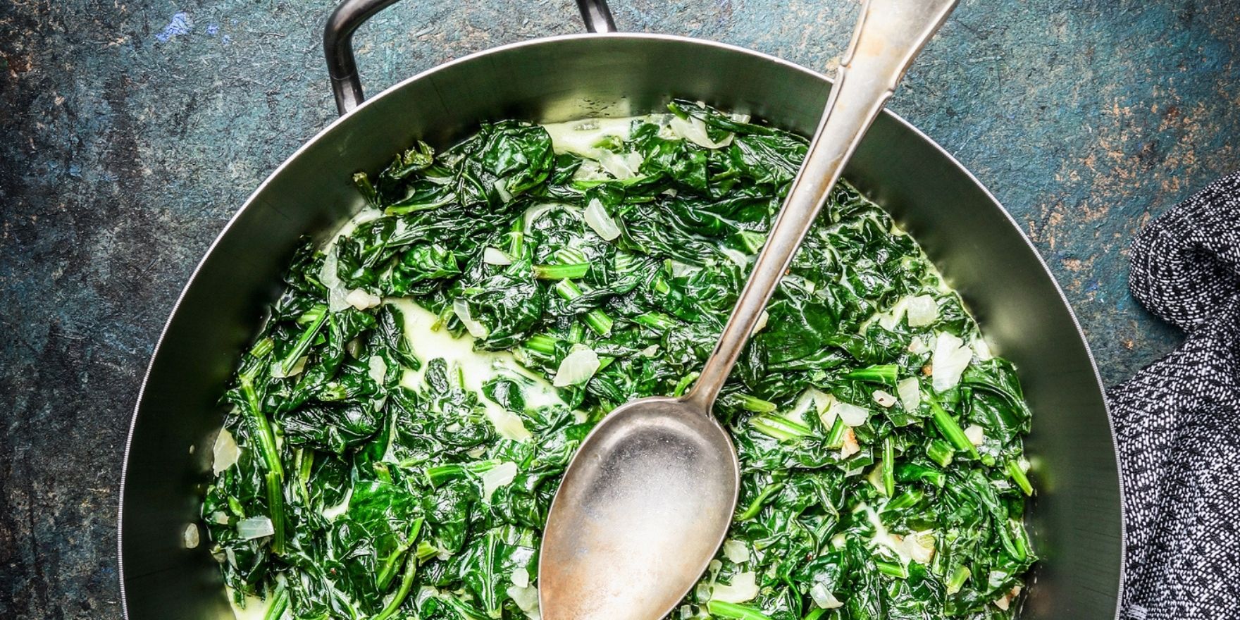A pan filled with creamed spinach