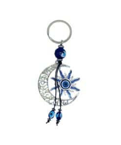 a crescent moon keychain with a blue eye bead in the center of a sun