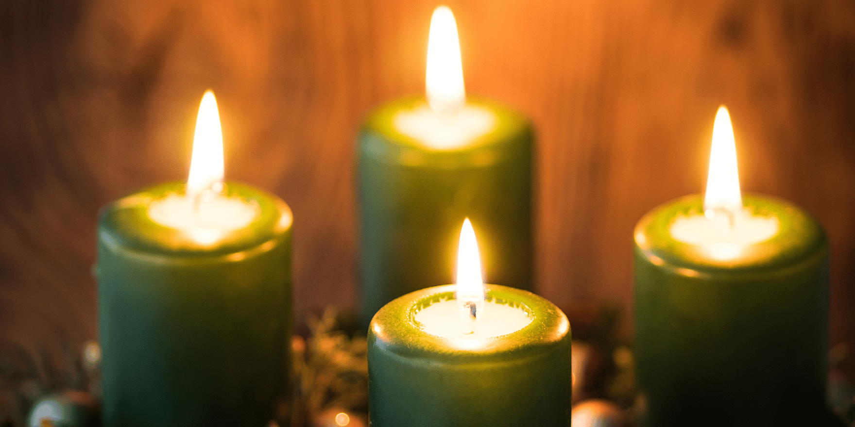 Four lit, green spell candles in a square