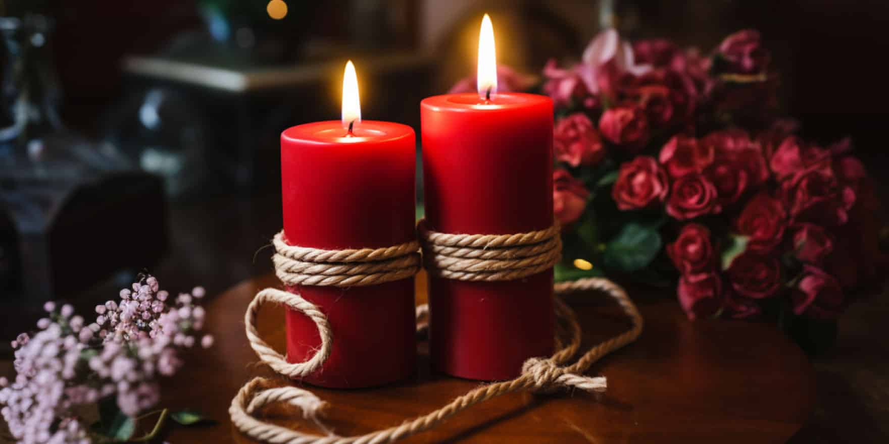 A love spell with two red candles bound by hemp rope