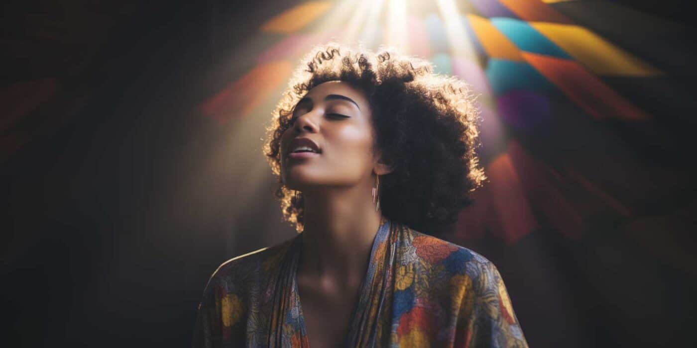 A woman of color bathed in rainbow light