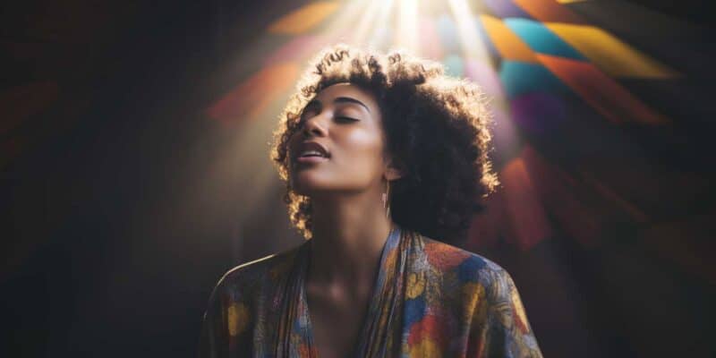 30 Positive Affirmations For November 1 A woman of color bathed in rainbow light