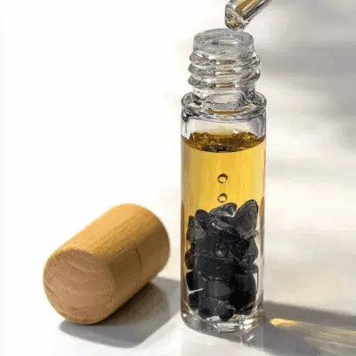 Glass bottle with oil and stones