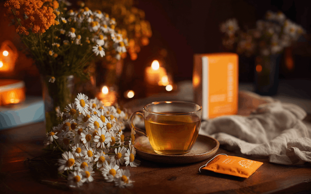 a cup of chamomile tea on a table surrounded by chamomile flowers