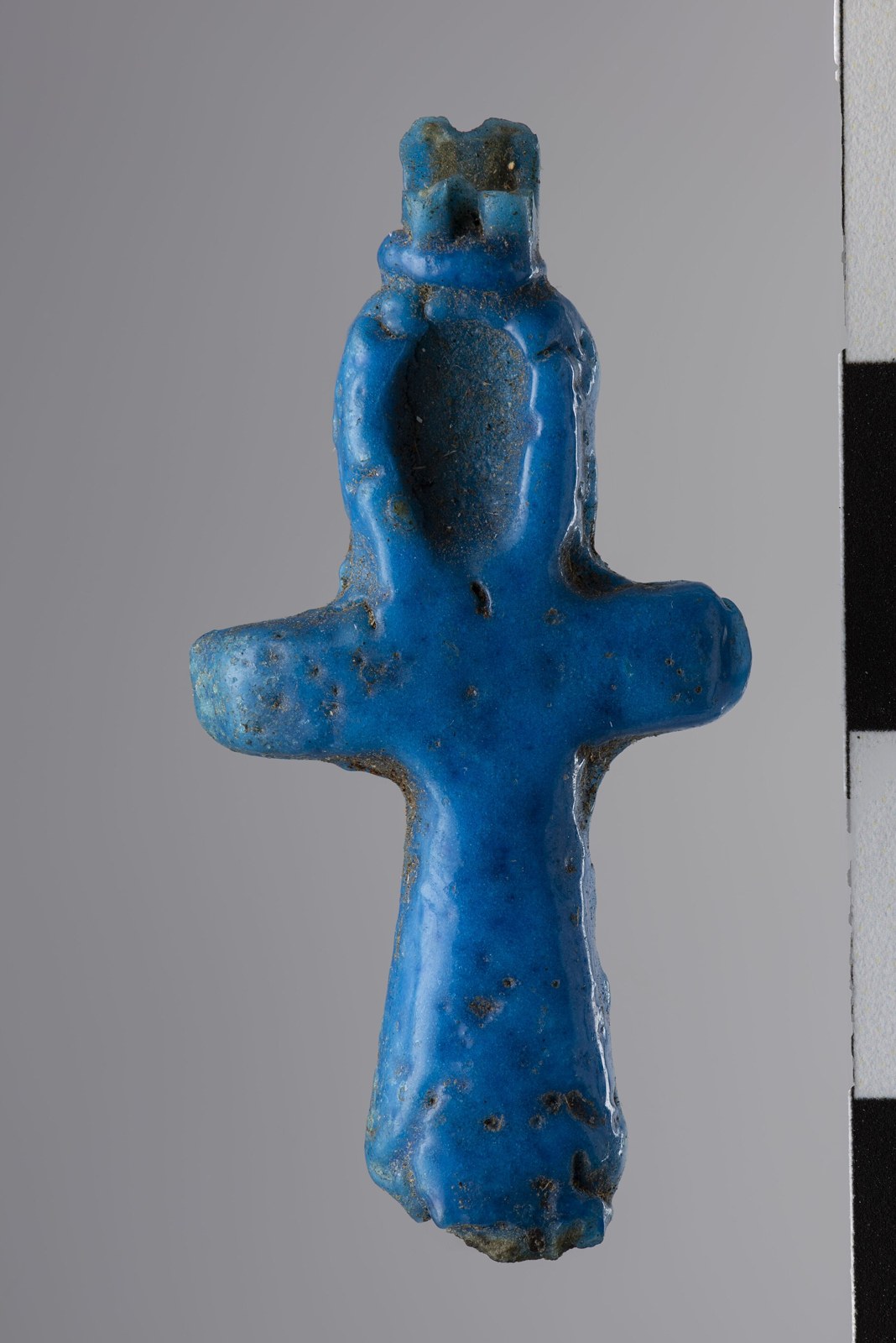 Faience ankh amulet Museo Egizio Plentiful Earth | Global Spirituality A small blue faience ankh amulet from ancient Egypt, photographed against a gray background