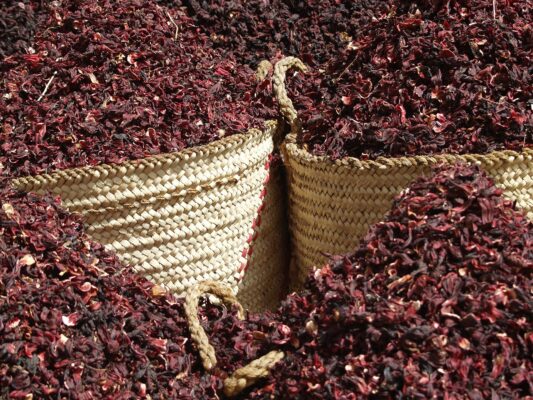 Baskets of dried red hibiscus calyces for karkadé at a market in Aswan Egypt Plentiful Earth | Global Spirituality Baskets of dried red hibiscus calyces for karkadé at a market in Aswan, Egypt