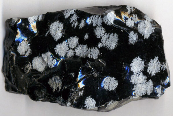 Snowflake obsidian Plentiful Earth | Global Spirituality A rough piece of snowflake obsidian with white cristobalite flakes in glossy black glass.
