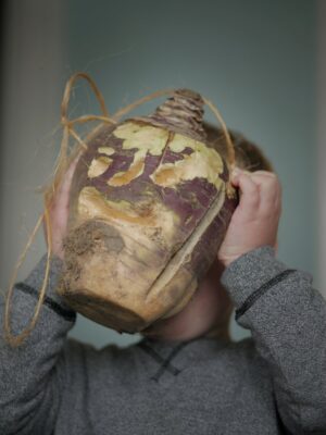 turnip lantern string handle Plentiful Earth | Global Spirituality A child holding up a carved turnip lantern by its string handle for Hop-tu-Naa on the Isle of Man.