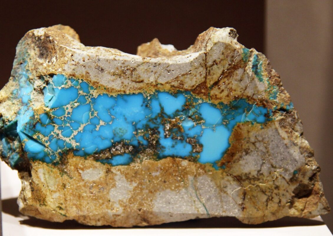 A vein of sky-blue turquoise running through tan and brown host rock, from the Cerrillos Hills of New Mexico.