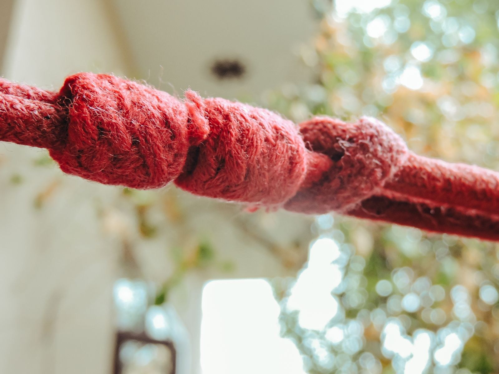 Knotted red cord Plentiful Earth | Global Spirituality Close-up of a red cord tied in a row of knots